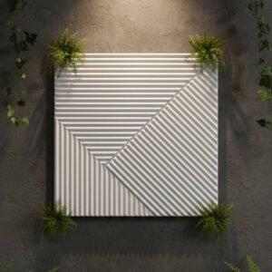 White 3D geometric wall panel with diagonal and horizontal fluted patterns, displayed on a dark textured wall with greenery and warm spotlighting.
