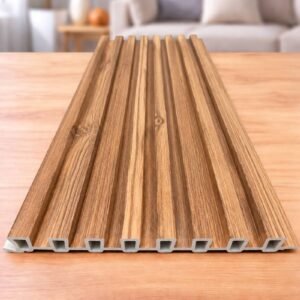 Wood finish fluted wall panel with a natural brown wood-grain texture displayed on a wooden surface.