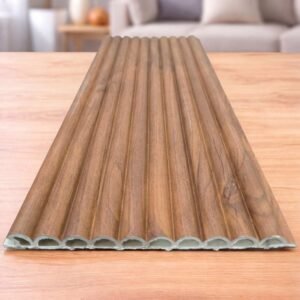 Wood finish fluted wall panel with vertical grooves displayed on a wooden surface.