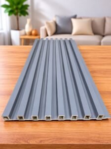 Grey fluted wall panel with vertical grooves displayed on a wooden table