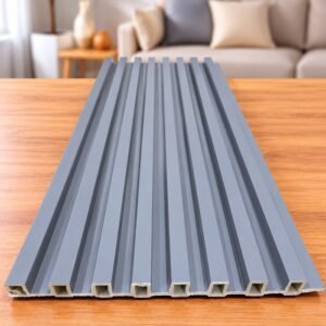 Grey fluted wall panel with vertical grooves displayed on a wooden table