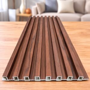 Walnut wood-finish fluted WPC panel displayed on a wooden tabletop in a modern living room.