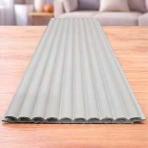 White fluted wall panel with a vertical ribbed design displayed on a wooden table
