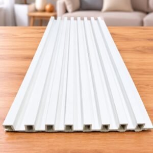 White grooved wall panel displayed on a wooden table in a modern living room.