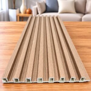 Beige wood-grain slatted wall panel displayed on a wooden table in a modern living room.