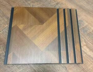 Brown geometric wood-finish fluted wall panel with dark grey vertical grooves and a modern angular pattern.