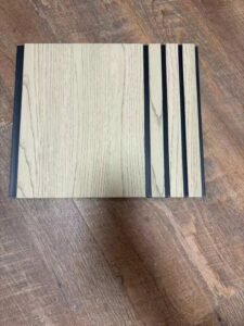 Cream white wood-texture fluted wall panel with vertical grooves and a minimalist design.