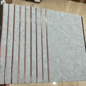 Light grey marble finish fluted panel with vertical grooves and rose-gold accent lines.