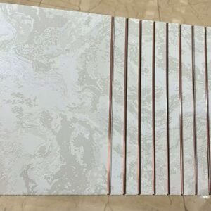 White marble finish fluted wall panel with rose gold vertical lines