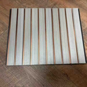 Light grey wood-texture fluted wall panel with vertical grooves and copper-gold decorative strips.