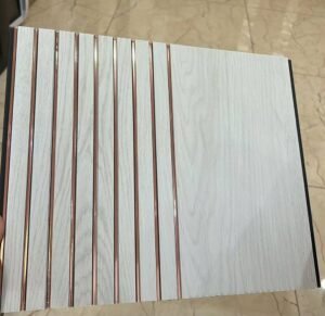 White marble finish fluted wall panel with rose gold vertical lines