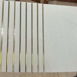 White marble finish fluted panel with elegant golden strips