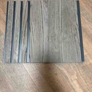 Grey wood-texture fluted wall panel with vertical grooves and dark recessed lines