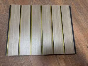 Light wood-finish fluted wall panel with vertical golden strips