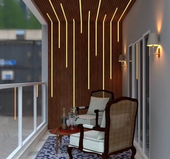 Modern luxury balcony featuring a dark wooden fluted wall and ceiling, warm linear LED lighting, elegant cane lounge chairs, a patterned blue rug, and a glass railing.